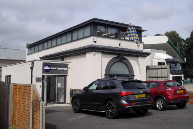 a white painted building, obviously the former now with an extension at the side and a second storey added.